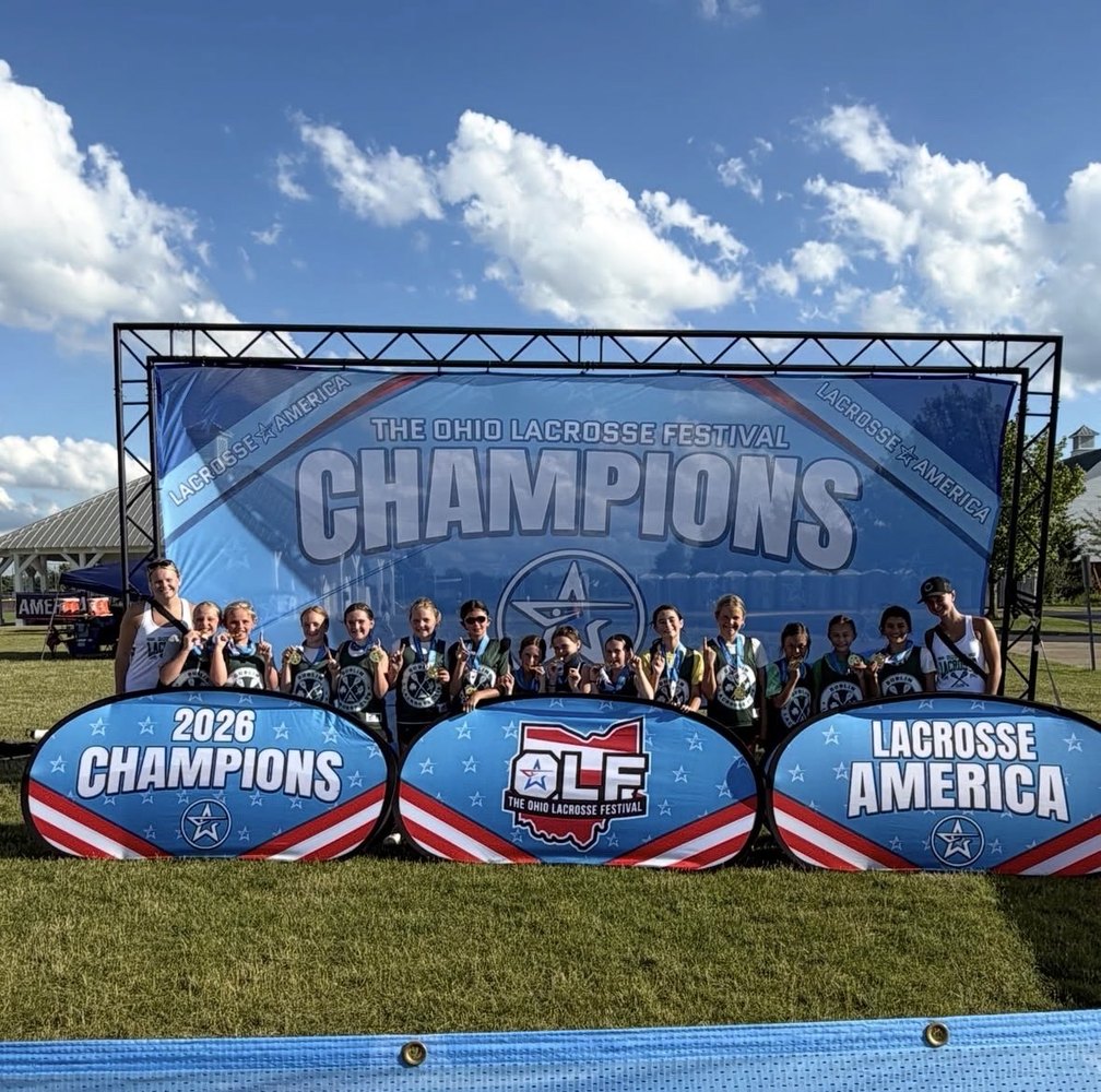 Dublin Lacrosse Club team with Ohio Lacrosse Festival champions banner